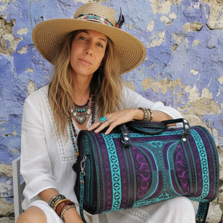 Woman holding a colorful bag against a textured wall background