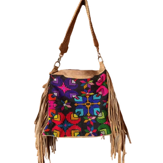 Colorful handbag with intricate patterns and fringes on a white background