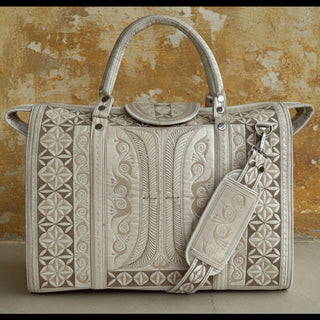 Decorative handbag with intricate patterns on a plain background