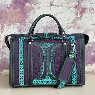 Purple and teal patterned handbag on a light wooden floor