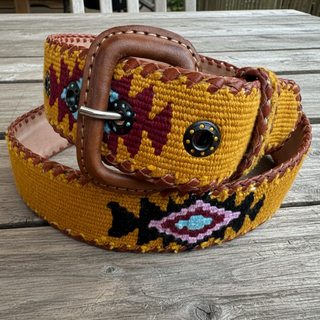Colorful belt with a brown buckle on a wooden surface